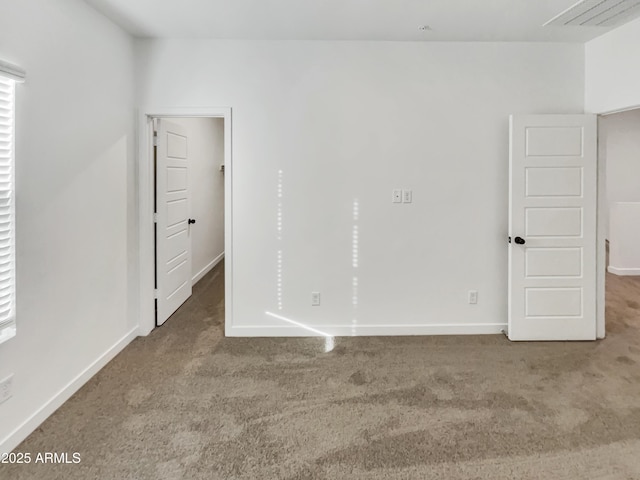 unfurnished bedroom with carpet and baseboards