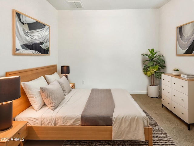 bedroom with light colored carpet, visible vents, and baseboards