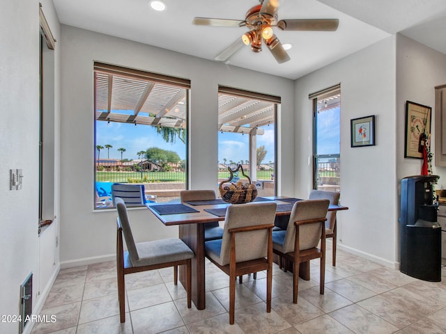 tiled dining room featuring ceiling fan