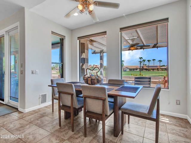 tiled dining space with ceiling fan