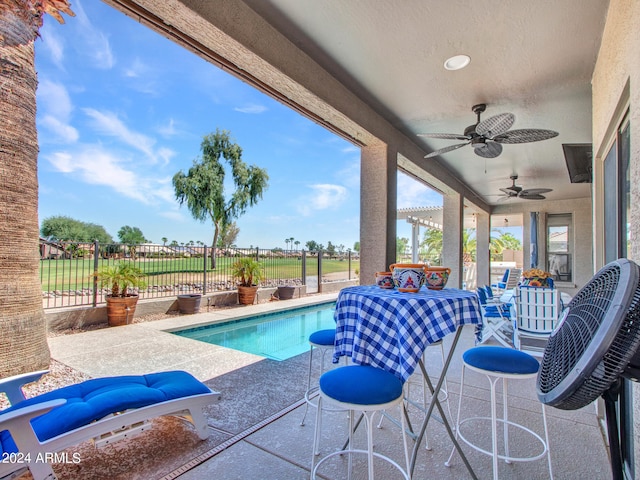 view of swimming pool featuring a patio and ceiling fan