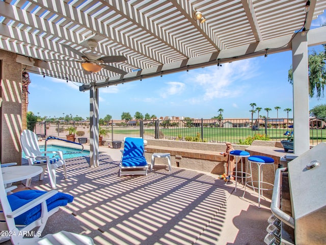 view of patio / terrace with a pergola, a fenced in pool, and ceiling fan