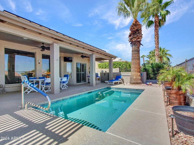 view of swimming pool featuring ceiling fan and a patio area