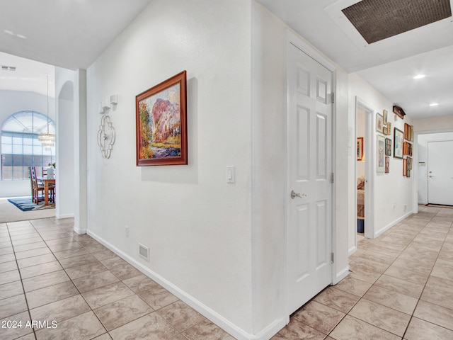 hallway featuring light tile patterned floors