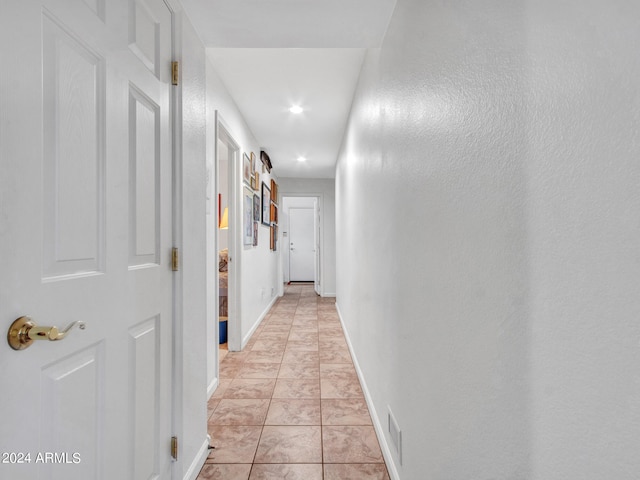 hallway featuring light tile patterned floors