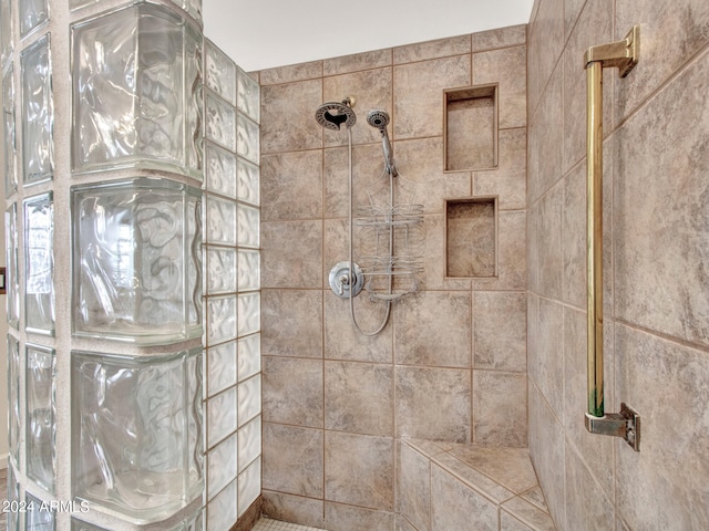 bathroom with tiled shower