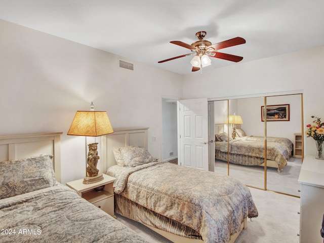 bedroom with light carpet, a closet, and ceiling fan