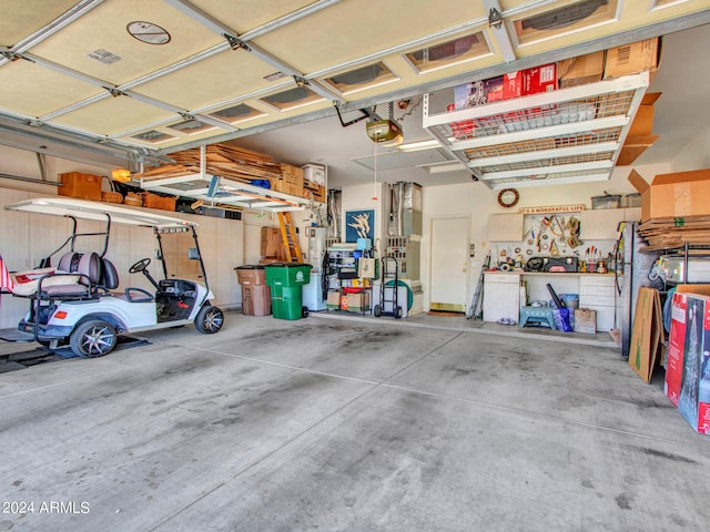 garage featuring a garage door opener and a workshop area