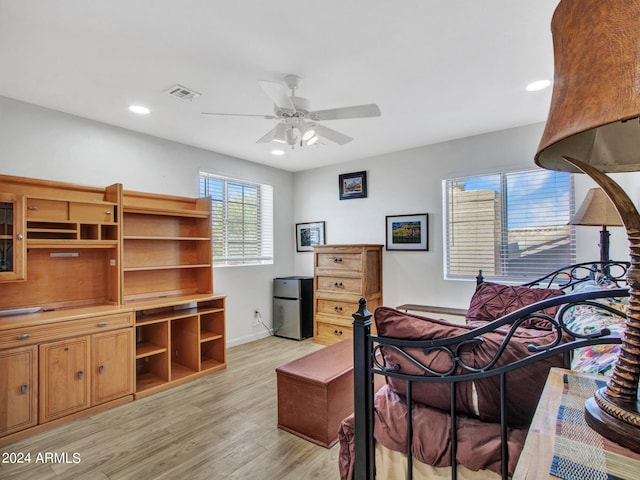 bedroom with light hardwood / wood-style floors and ceiling fan