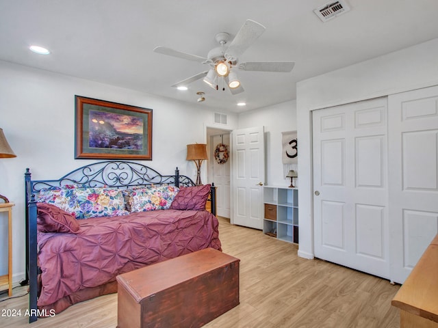 bedroom featuring ceiling fan, a closet, and light hardwood / wood-style floors