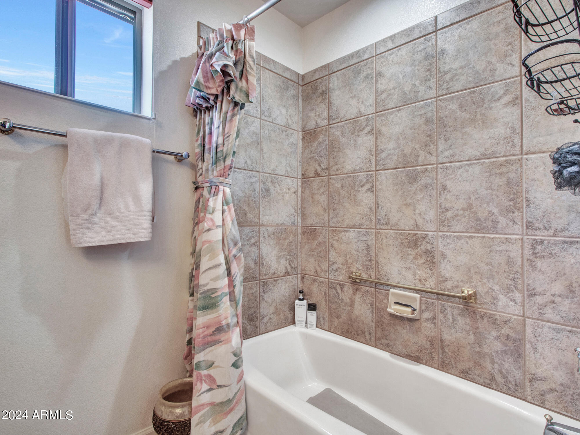 bathroom featuring shower / bathtub combination with curtain