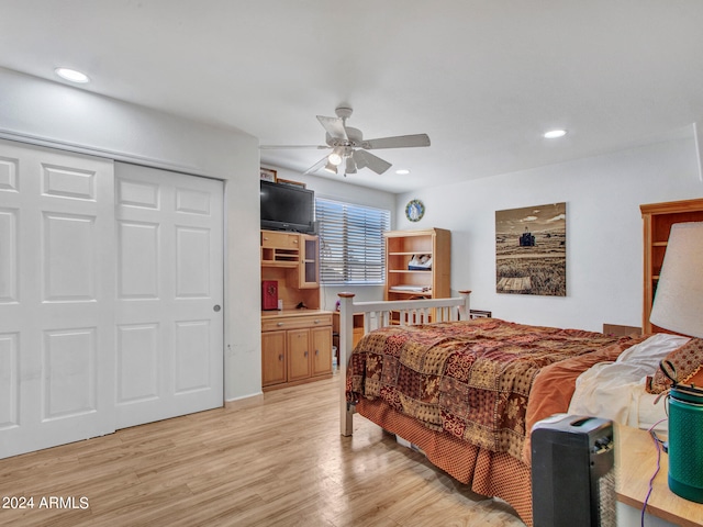 bedroom featuring light wood-type flooring, a closet, and ceiling fan