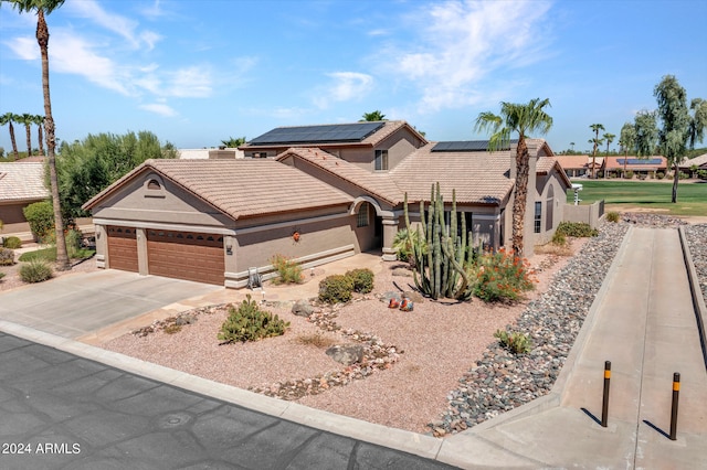 view of front of property with solar panels and a garage