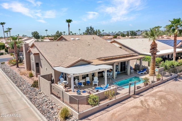 exterior space featuring a fenced in pool and a patio area