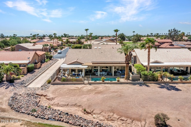 back of house with a pool and a patio area