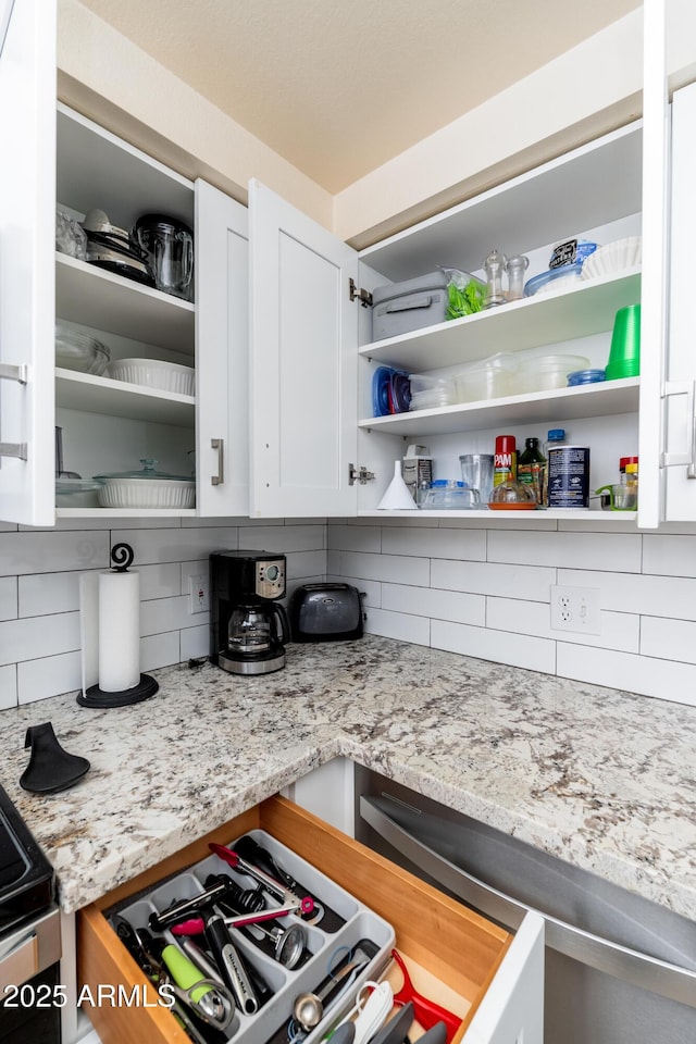 kitchen featuring open shelves, decorative backsplash, white cabinetry, and light stone countertops