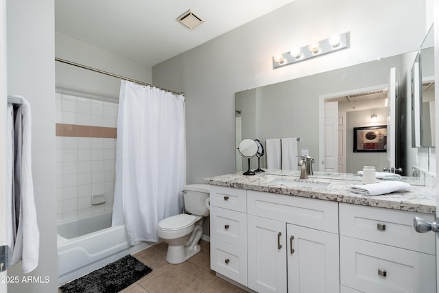 bathroom featuring toilet, tile patterned floors, vanity, and shower / tub combo with curtain