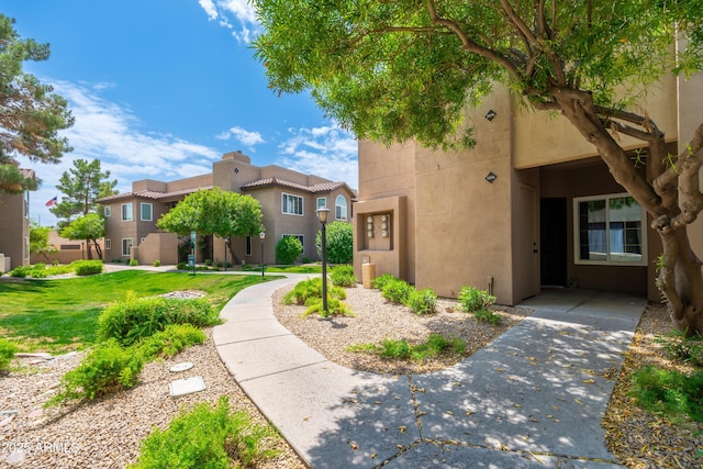 view of front of property featuring stucco siding and a front lawn