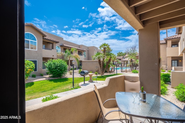 balcony with a residential view and view of pool