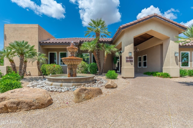 view of front of property with stucco siding and a tiled roof