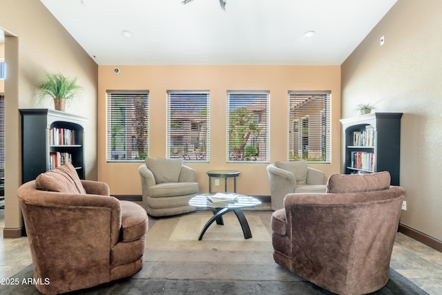 living area featuring plenty of natural light and baseboards