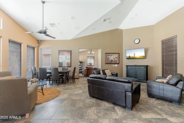 living area with high vaulted ceiling and a ceiling fan