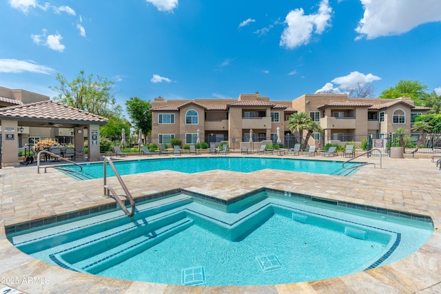 community pool featuring fence, a patio, and ceiling fan
