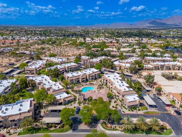 aerial view of a mountainous background and a pool area