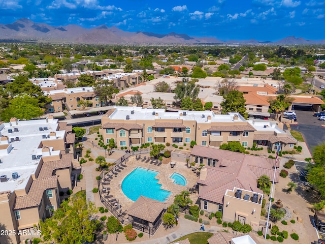drone / aerial view of a pool and a mountain backdrop