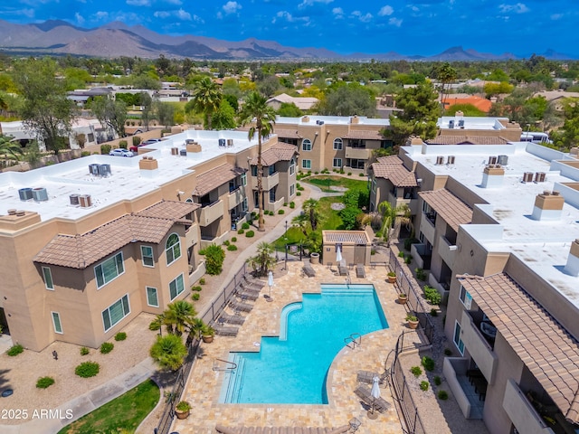 bird's eye view of a mountain backdrop and a pool area
