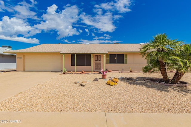 ranch-style home featuring a garage, stucco siding, and concrete driveway