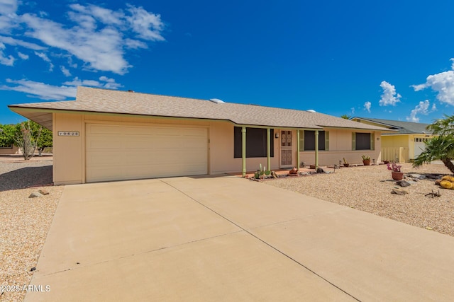 ranch-style house with concrete driveway and an attached garage