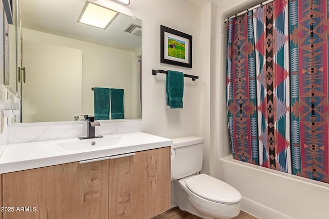 bathroom featuring visible vents, toilet, vanity, and shower / bath combination with curtain
