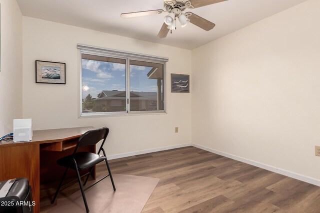 office featuring ceiling fan, baseboards, and wood finished floors