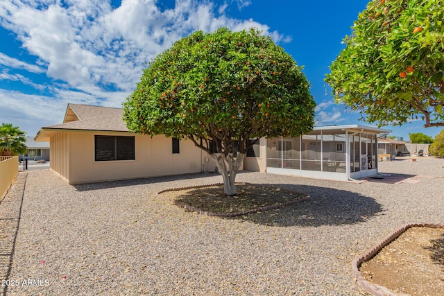 view of front of house with fence and a sunroom