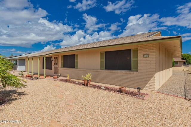 single story home featuring brick siding