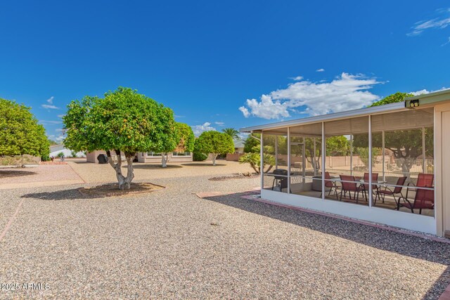 view of yard with a sunroom
