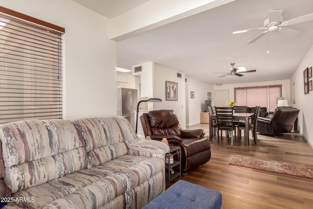 living area with wood finished floors, ceiling fan, and visible vents