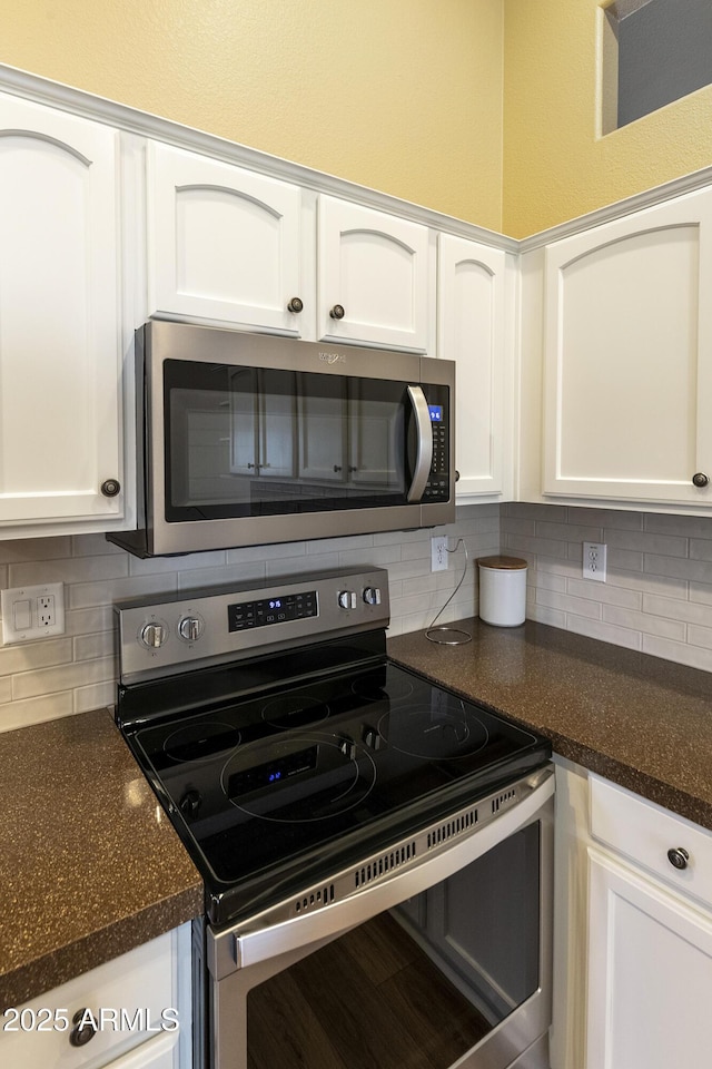 9216 E Rocky Lake Dr, Sun Lakes, AZ 85248 - kitchen with white cabinetry, dark countertops, and appliances with stainless steel finishes