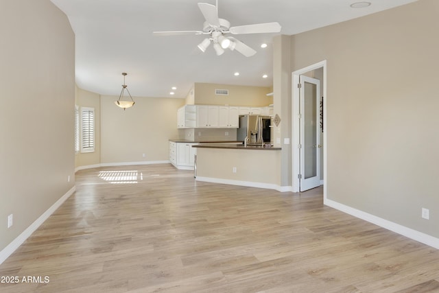 9216 E Rocky Lake Dr, Sun Lakes, AZ 85248 - unfurnished living room with ceiling fan, visible vents, vaulted ceiling, and baseboards