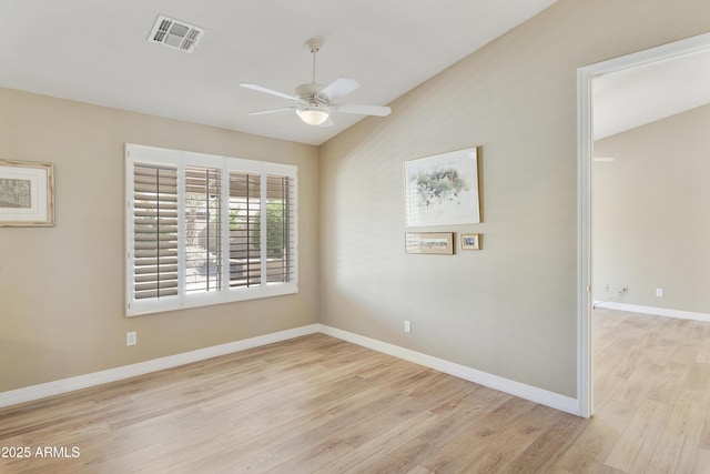 9216 E Rocky Lake Dr, Sun Lakes, AZ 85248 - empty room featuring visible vents, ceiling fan, vaulted ceiling, and wood finished floors