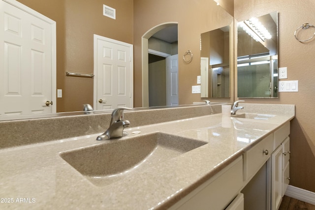 9216 E Rocky Lake Dr, Sun Lakes, AZ 85248 - full bath featuring double vanity, a sink, baseboards, and visible vents