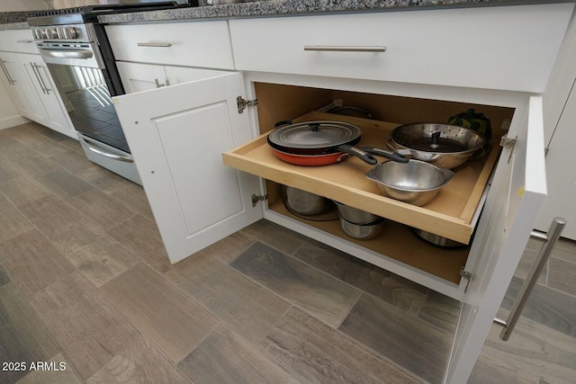 room details with stainless steel range and white cabinets