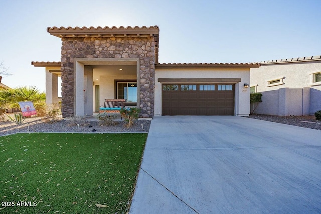 mediterranean / spanish-style house featuring a front lawn and a garage