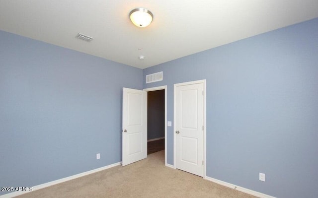 unfurnished bedroom with light carpet