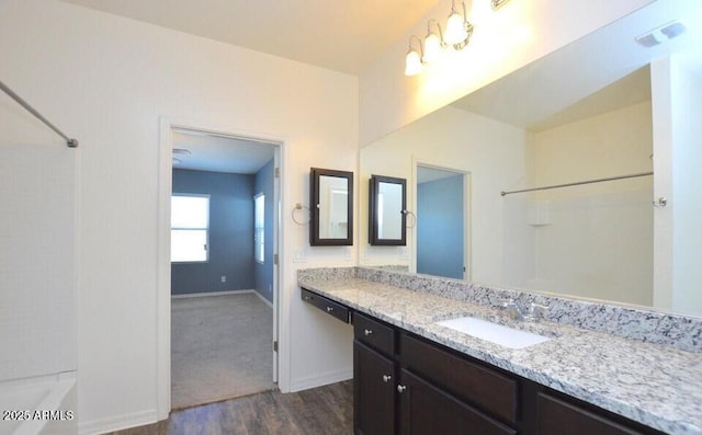 bathroom with vanity, hardwood / wood-style floors, and bathing tub / shower combination