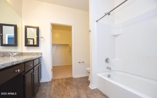 full bathroom with vanity, hardwood / wood-style floors,  shower combination, and toilet