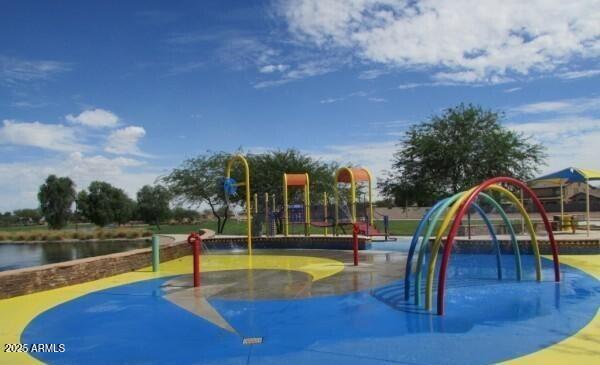 view of jungle gym featuring a water view