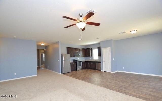 kitchen with dark colored carpet, ceiling fan, appliances with stainless steel finishes, and dark brown cabinetry