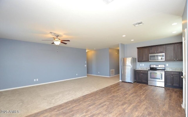 kitchen with ceiling fan, appliances with stainless steel finishes, dark wood-type flooring, and dark brown cabinetry